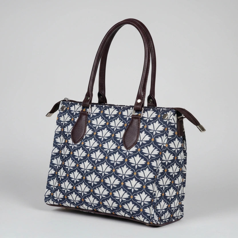 Close-up of the strong PU leather handle on the women's floral cotton handbag.
