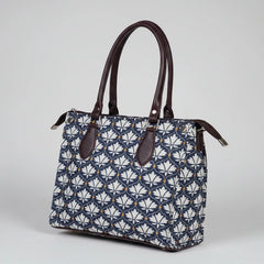 Close-up of the strong PU leather handle on the women's floral cotton handbag.