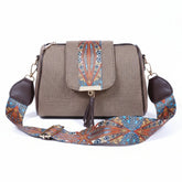 Women's jacquard crossbody sling bag with printed flap and leather tassel