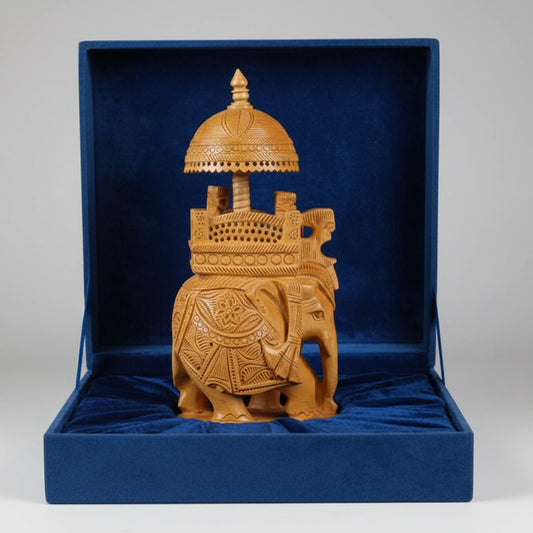 Hand-carved wooden Ambabari elephant placed inside a luxury red velvet-lined gift box for premium presentation.