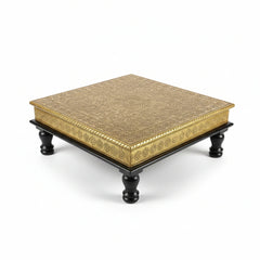 Strong wooden chowki stool being used for sitting during a traditional puja or wedding ceremony.