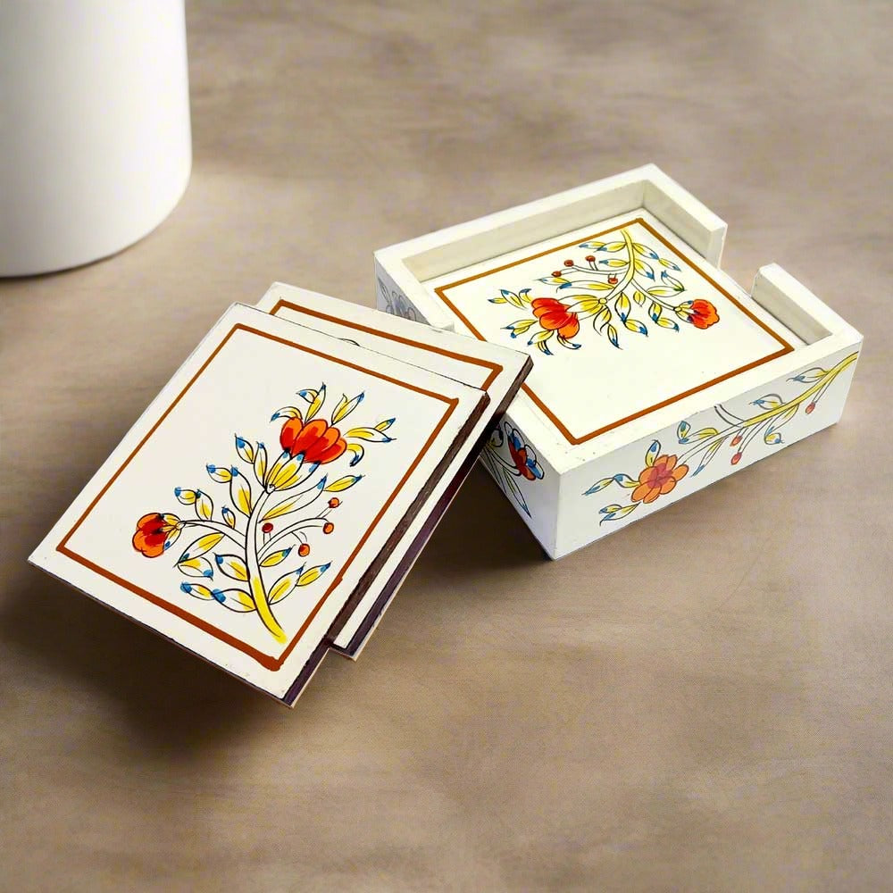 A wooden coaster set with a holder, featuring a beautiful handmade floral design.