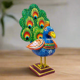 A wooden peacock statue in a dancing pose with beautifully spread wings and colorful hand painting.