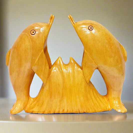 Handmade wooden dolphin statue featuring two dolphins facing each other.