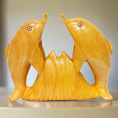 Handmade wooden dolphin statue featuring two dolphins facing each other.
