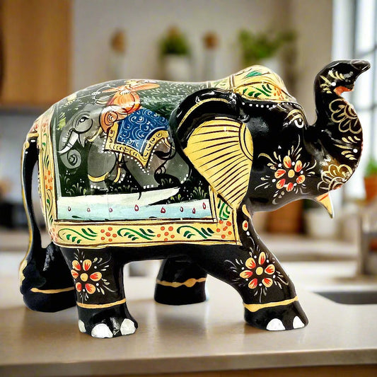 A wooden elephant figurine with intricate hand-painted miniature painting.