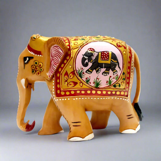 A handmade wooden elephant statue with a low trunk, featuring beautiful emboss and elephant painting.
