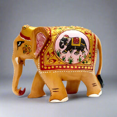 A handmade wooden elephant statue with a low trunk, featuring beautiful emboss and elephant painting.