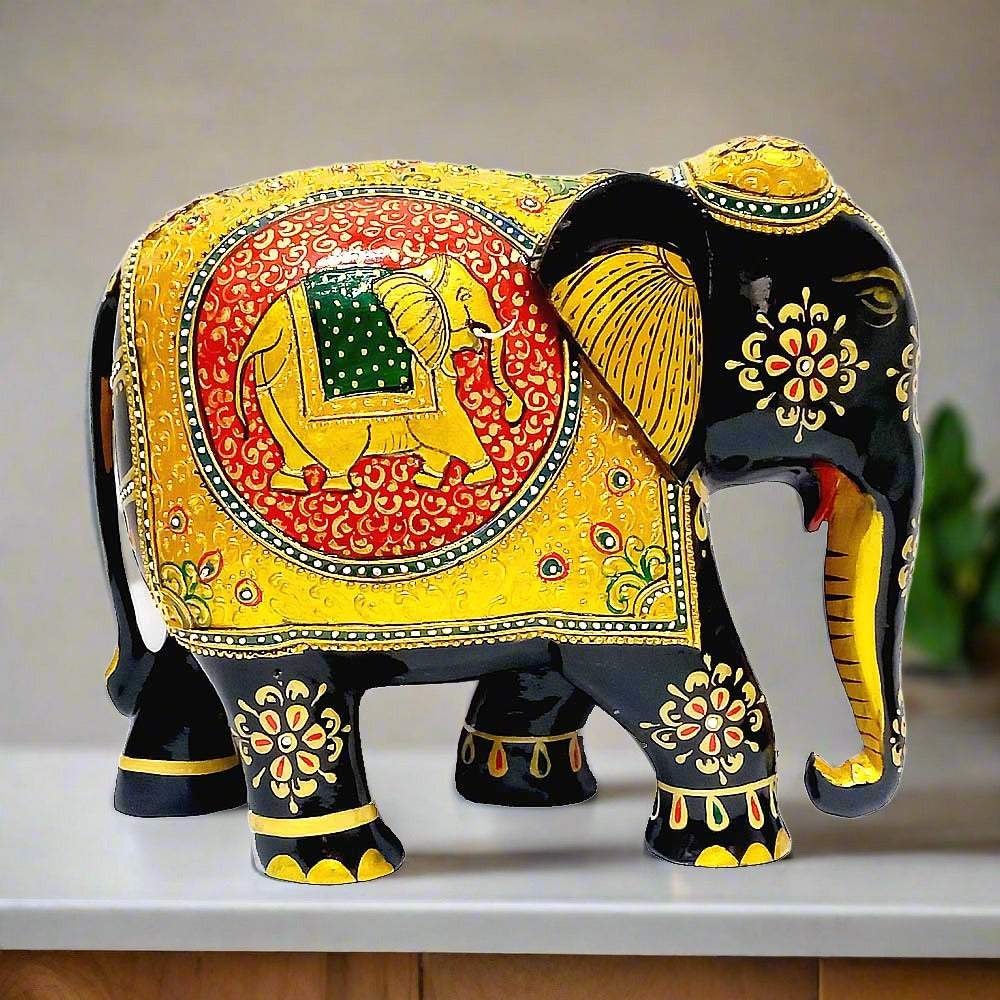 A wooden elephant statue with hand-painted embossing of elephants and florals.