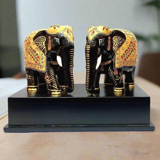 The double elephant wooden memento displayed as a centerpiece on a professional office desk, showcasing its premium finish.