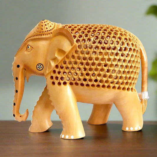 A wooden elephant statue with a baby elephant carved inside, a fine example of Indian craftsmanship.
