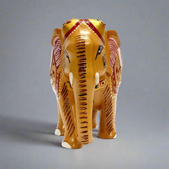 A wooden elephant statue with wooden teeth, a unique and decorative piece.