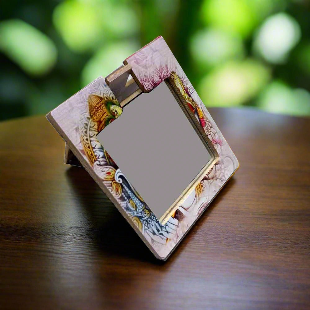A wooden hand mirror with a very beautiful lady design painting on it.