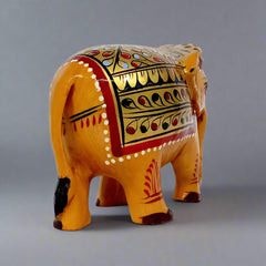 Hand-painted wooden elephant featuring red and green floral artwork on gold background, perfect decorative gift item
