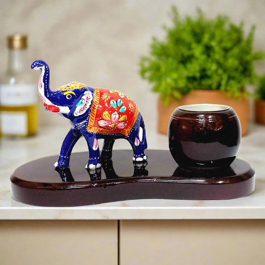 A beautiful handmade elephant candle holder made of wood and metal, decorated with magnificent Meenakari painting.