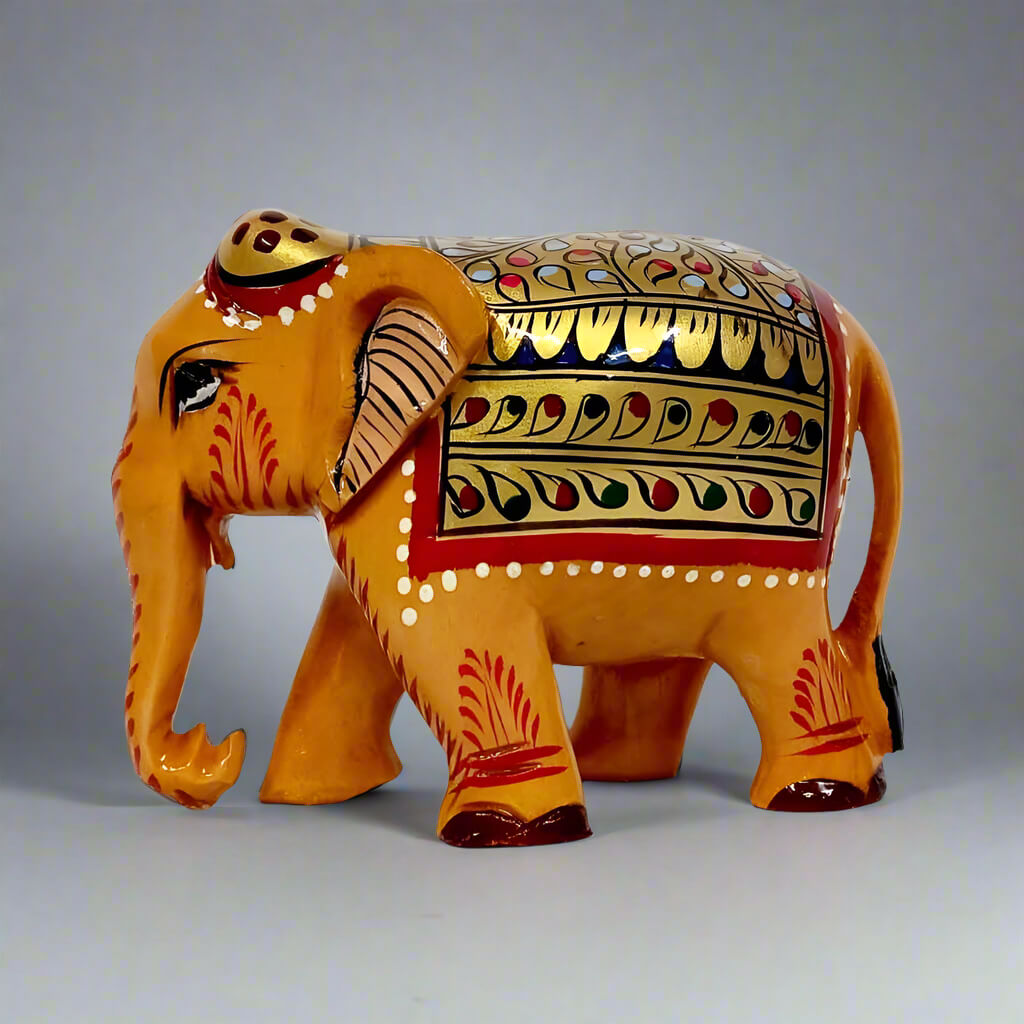 Wooden elephant statue with hand-painted red and green floral design on gold stomach, back, and forehead, ideal for home decor and gifting