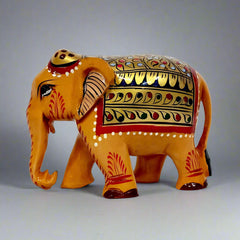 Wooden elephant statue with hand-painted red and green floral design on gold stomach, back, and forehead, ideal for home decor and gifting