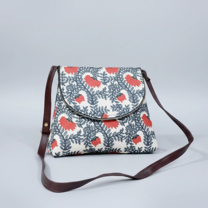Front view of an 8x9 inch woven floral sling bag featuring a textured fabric body and tan PU leather accents.