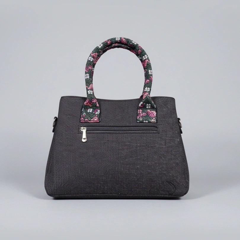 Rear view of jacquard woven handbag showing the secure back zip pocket