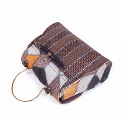 Rear view of textured sling bag showing secure back zip pocket