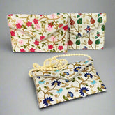 Elegant Zari and embroidery clutch bag with intricate detailing, perfect as a Navratri return gift