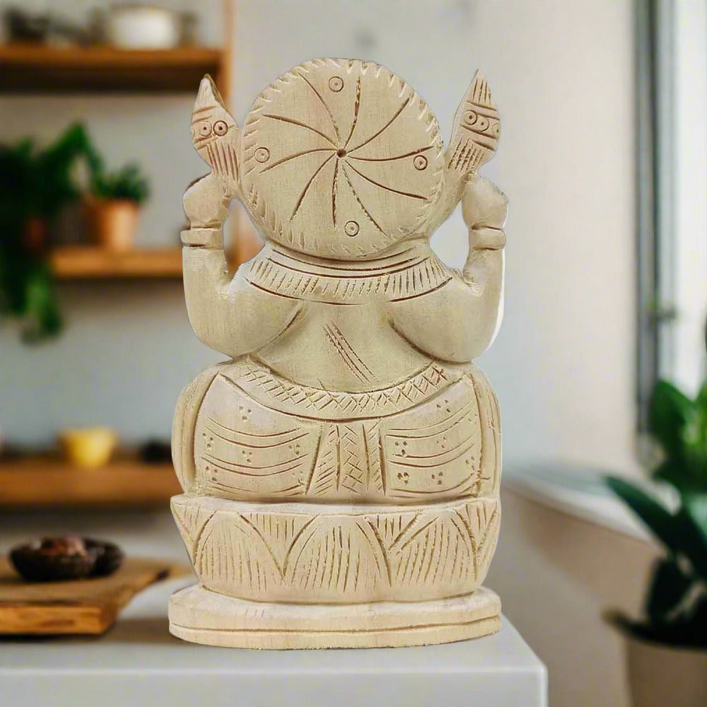 A 15cm carved wooden Ganesh figurine, a beautiful piece for home or office decor.