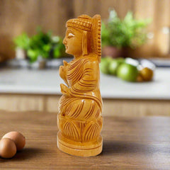 A 15cm round wooden Buddha sculpture, a serene addition to any room.