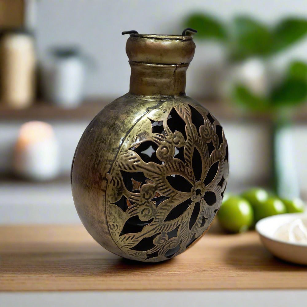 A 20cm golden oxidized metal candle holder with a unique mesh design.