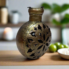 A 20cm golden oxidized metal candle holder with a unique mesh design.