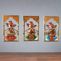 A 26cm metal Ganesha showpiece set with three frames for wall decor.