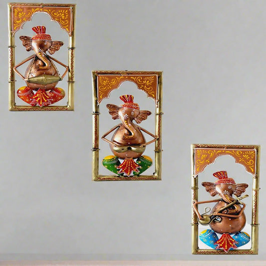A 3-piece set of metal Ganesha frames, with each Ganesha playing a different musical instrument.