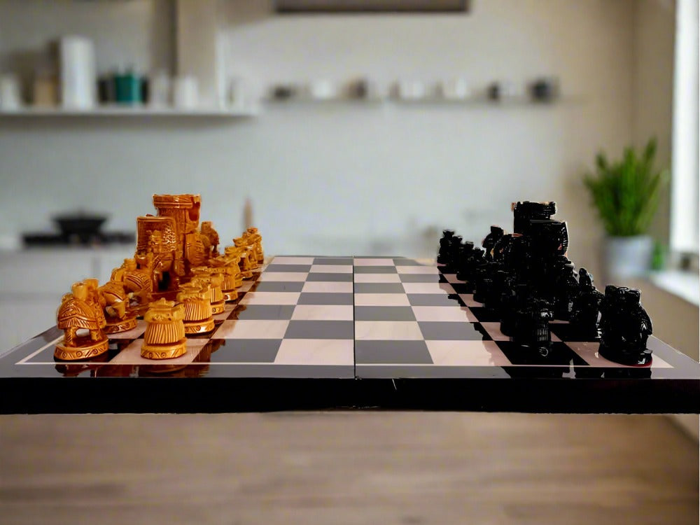 A wooden chess set with Ambari elephant figurine pieces, including a 15-inch x 15-inch playing board.