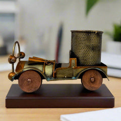 Antique hand-painted metal pen holder in the shape of a vintage car, ideal for office desk organization.