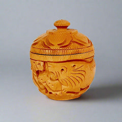 Artisan-crafted round wooden kumkum box featuring bangle style threading and detailed handiwork.