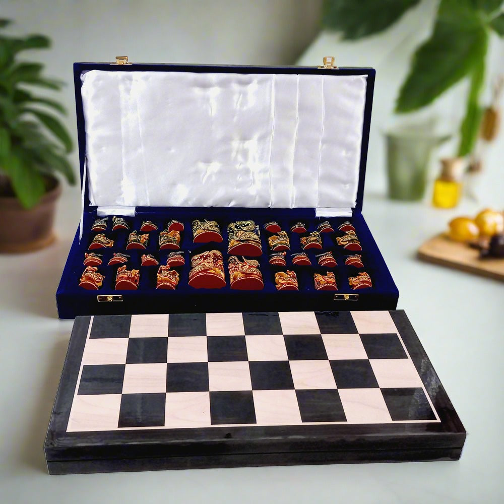 Artistic handpainted chess pieces on wooden chessboard, featuring red and green colors and Indian traditional art style.