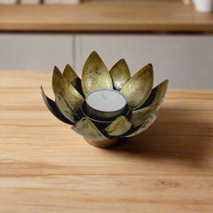Artistic metal candle holder showcasing lotus bloom motif, enhancing spiritual ambiance in any space.