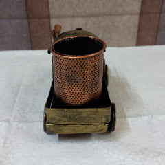 Artistic train-shaped metal pen stand with antique design and hand-painted details, perfect for gifting.