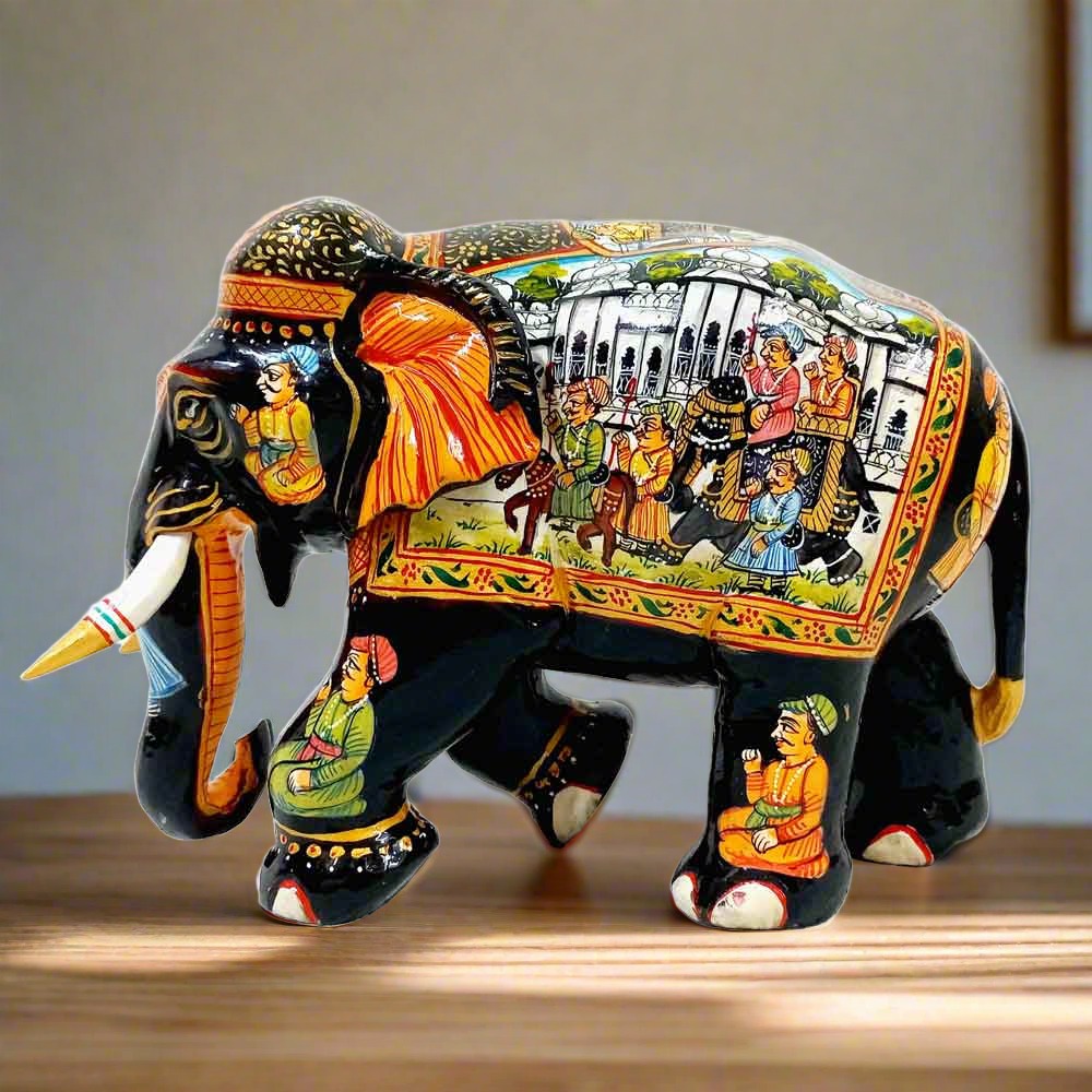Artistic wooden elephant decorated with exquisite Mughal miniature paintings, combining vibrant colors with black wood.