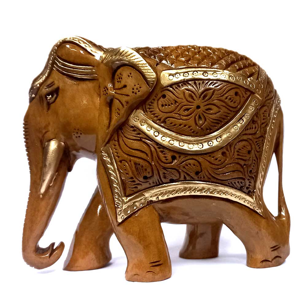 A brown carved elephant with intricate carvings on its back and belly.