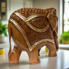 A beautiful wooden elephant figurine with a brown oxidized polish and decorated with gold paint.