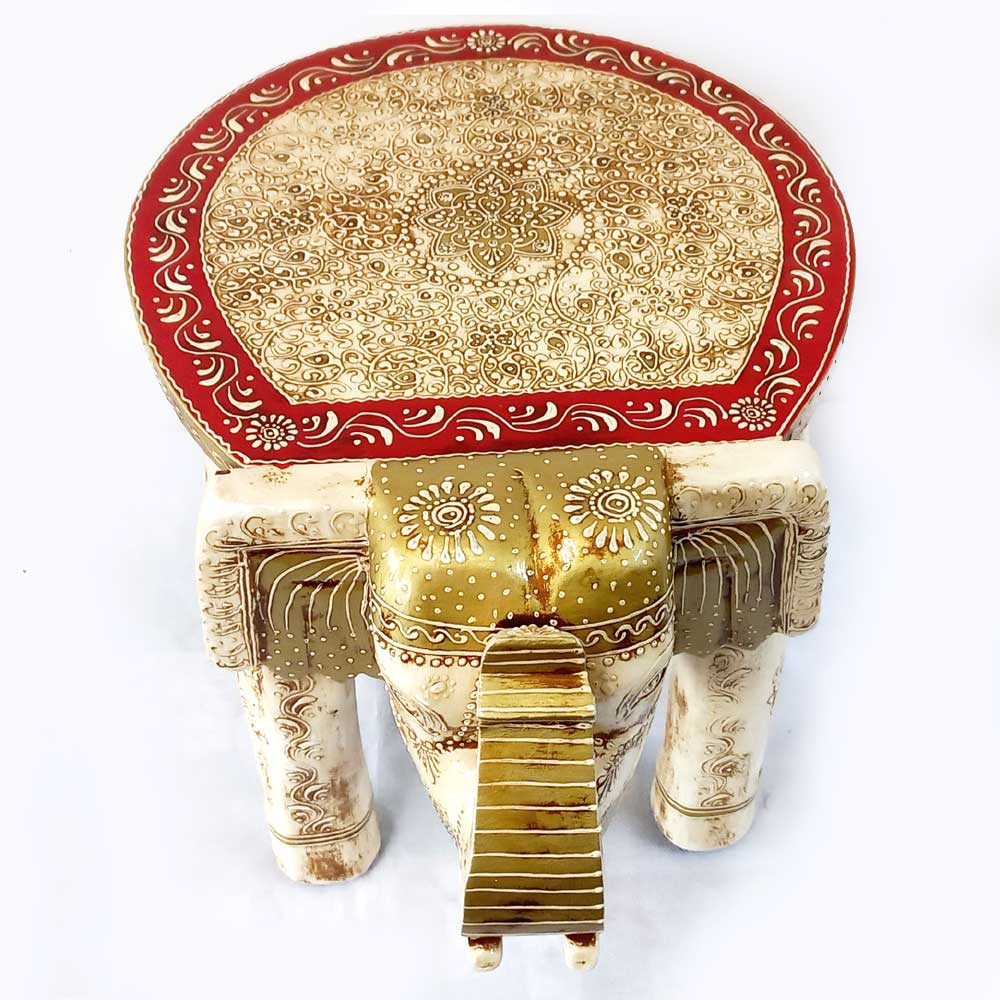 An intricately carved ivory-colored elephant showpiece with beautiful golden and red paint details.