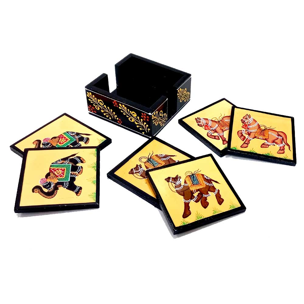 A gorgeous carved wood coaster set with a floral design on the stand and paintings of camel, horse, and elephant.