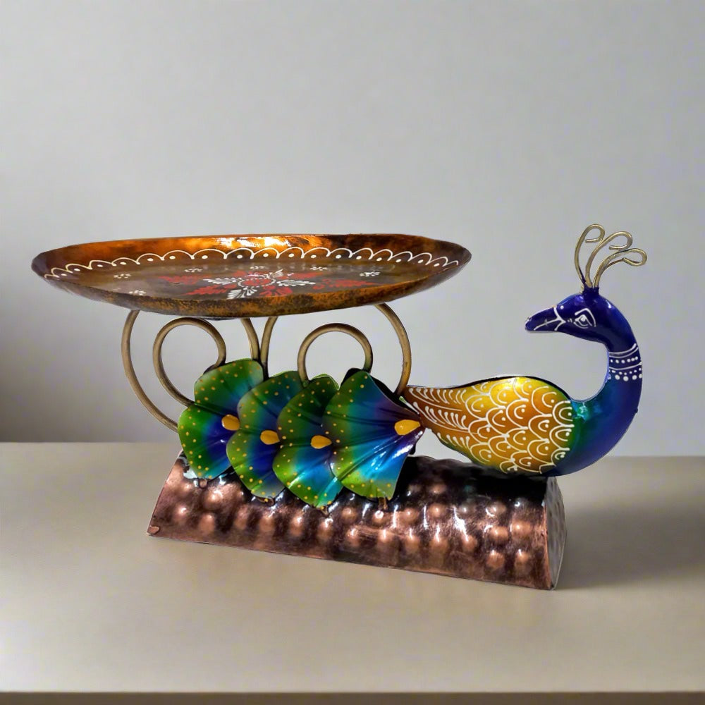Colorful metal peacock platter featuring detailed hand painting, ideal for use as a beautiful home decor item.