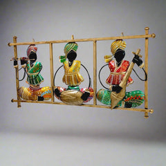 Colorful metal Rajasthani musician wall hanging with hand-painted details and figures playing tabla, flute, and veena.