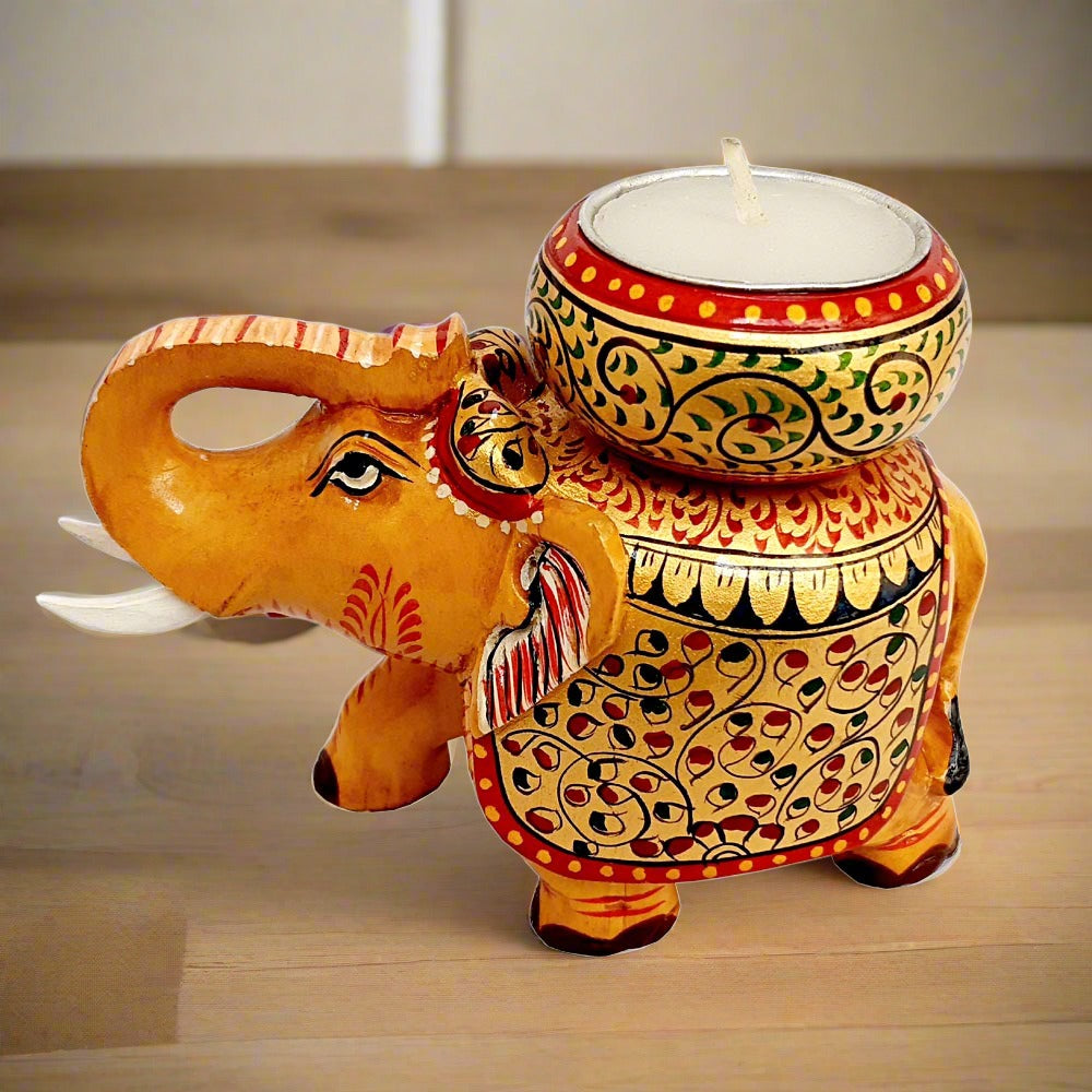 Colorful wooden elephant candle holder painted in gold, red, blue, and black, perfect as a decorative piece.