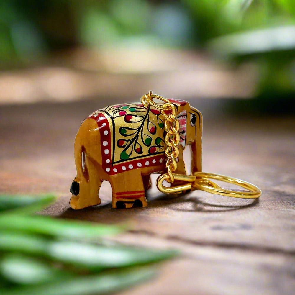 A cute little wooden key holder with an elephant design and a long-lasting golden ring.