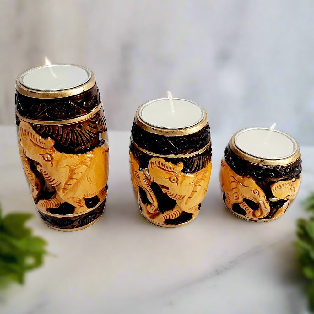 An awesome dark brown elephant candle holder set with three pieces in graduated sizes (10cm, 8cm, 5cm).