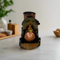 Decorative antique train-shaped metal pen holder featuring artisan hand painting, admired on office desks.