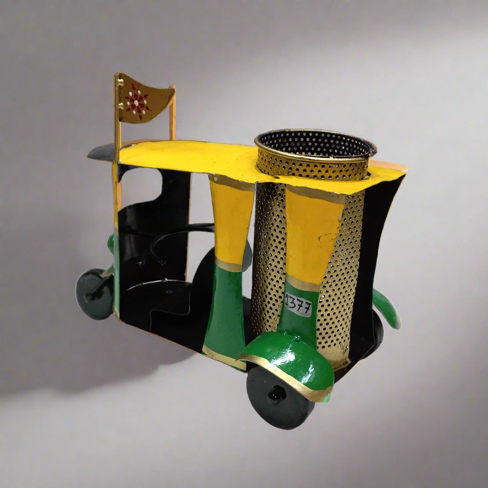 Decorative auto rickshaw shaped metal pen holder with colorful hand painting, suited for office or home use.