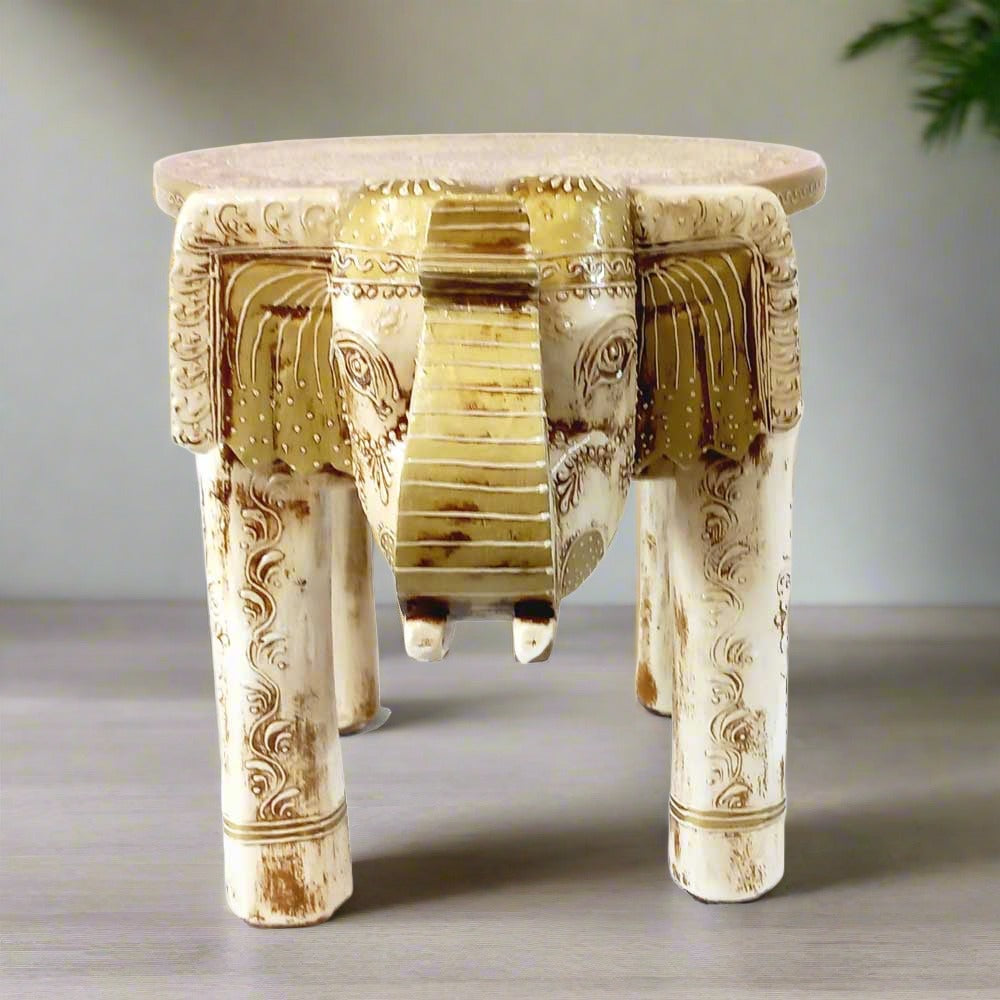 A decorative elephant stool with fine carving, perfect for home or office decor.